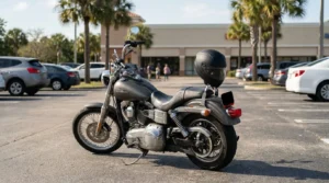 Harley-Davidson motorcycle with helmet on seat parked in commercial parking lot